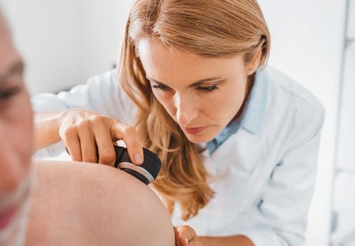 Dermatologist performing a skin cancer screening